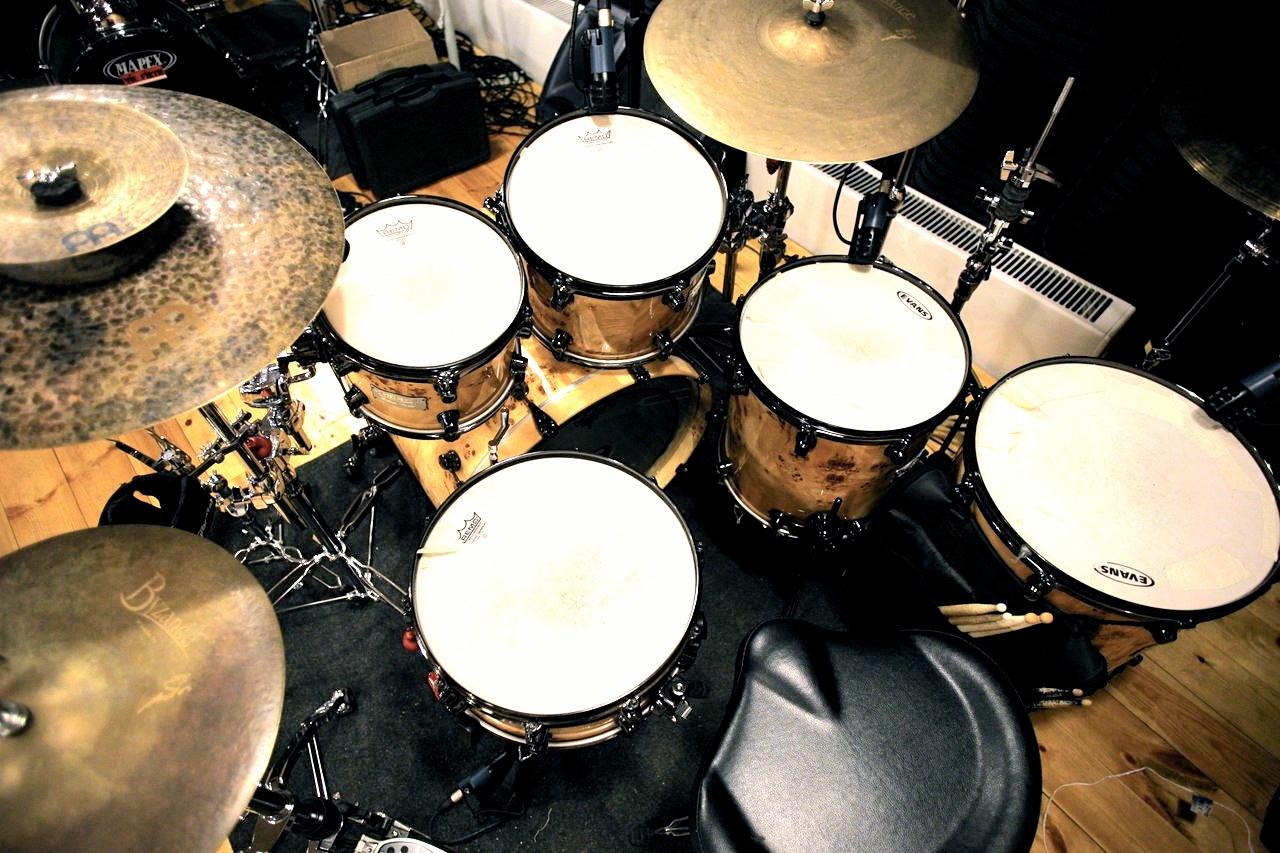 Professional drum instructor teaching dynamic drumming techniques in modern studio